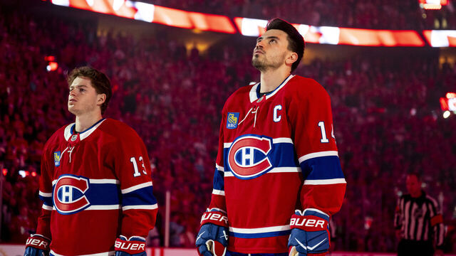 MONTREAL, CANADA- APRIL 24: Nick Suzuki #14 and Cole Caufield #13 of the Montreal Canadiens look on during the national anthems before Game Three of the First Round of the 2026 Stanley Cup Playoffs against the Tampa Bay Lightning at the Bell Centre on April 24, 2026 in Montreal, Quebec, Canada.