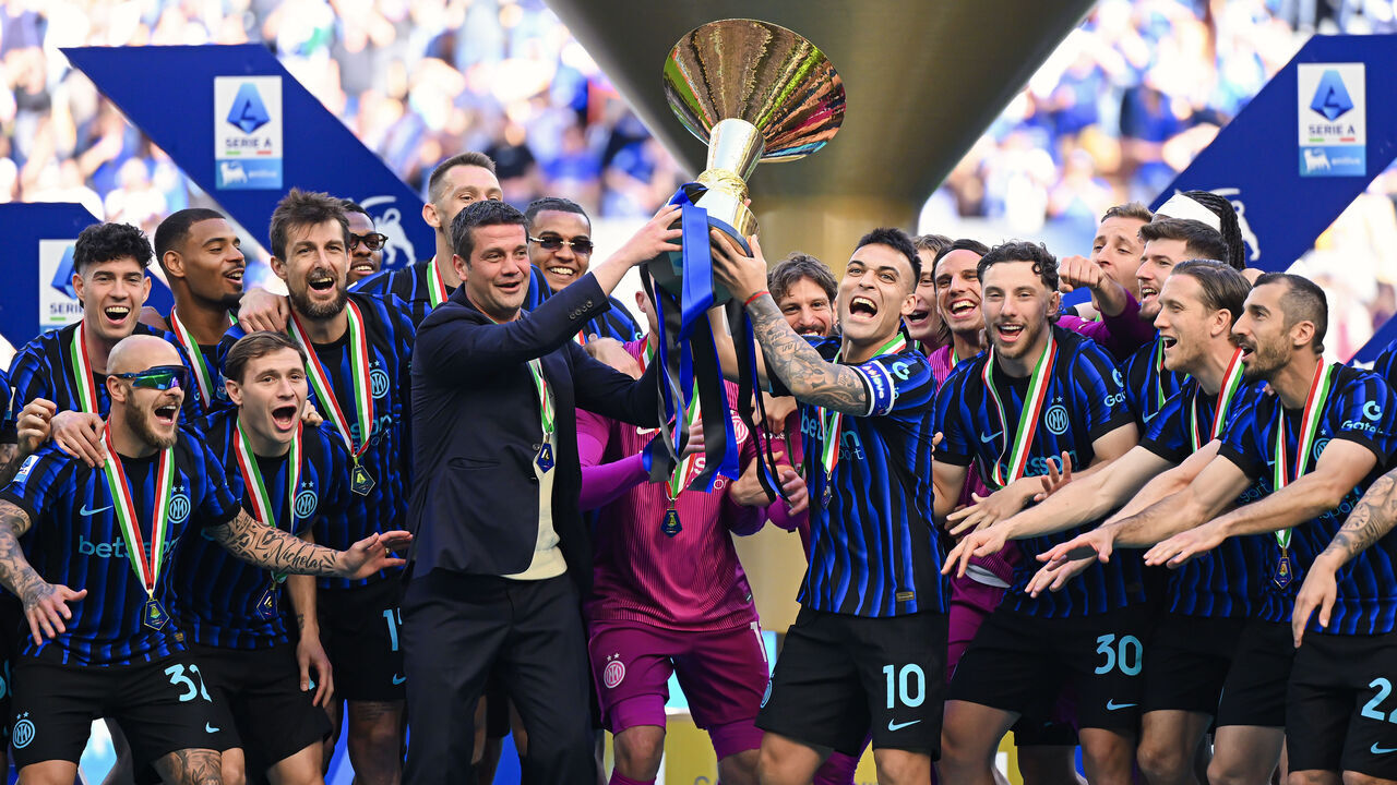MILAN, ITALY - MAY 17: (L-R) Head Coach Cristian Chivu of FC Internazionale and Lautaro Martinez of FC Internazionale lift the Serie A Trophy alongside team-mates after winning the Serie A match between FC Internazionale and Hellas Verona FC at Giuseppe Meazza Stadium on May 17, 2026 in Milan, Italy.