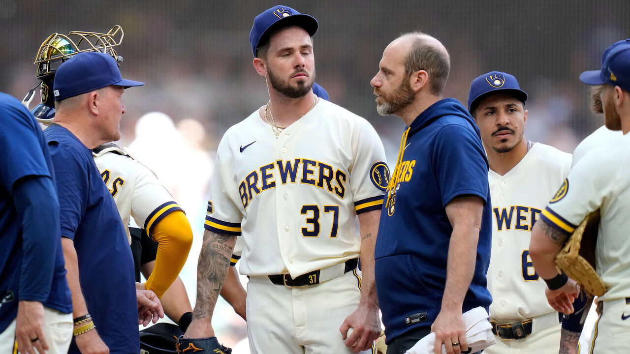 MILWAUKEE, WISCONSIN - JUNE 04: DL Hall #37 of the Milwaukee Brewers leaves the game in the fifth inning with an injury as head athletic trainer Brad Epstein looks on against the San Francisco Giants at American Family Field on June 04, 2026 in Milwaukee, Wisconsin.