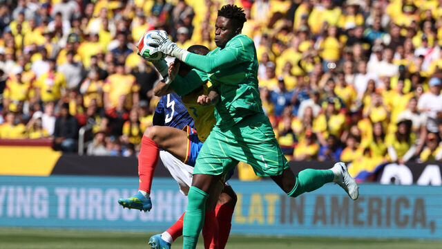 France's goalkeeper #01 Brice Samba makes a save challenged by Colombia's forward #07 Luis Diaz during a friendly football match between Colombia and France at Northwest Stadium in Landover, Maryland, on March 29, 2026.