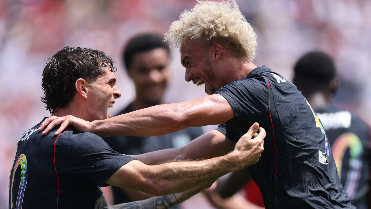 CHICAGO, ILLINOIS - JUNE 06: Antonee Robinson of United States celebrates with teammate Christian Pulisic after scoring his team's first goal during the international friendly match between United States and Germany at Soldier Field on June 06, 2026 in Chicago, Illinois.