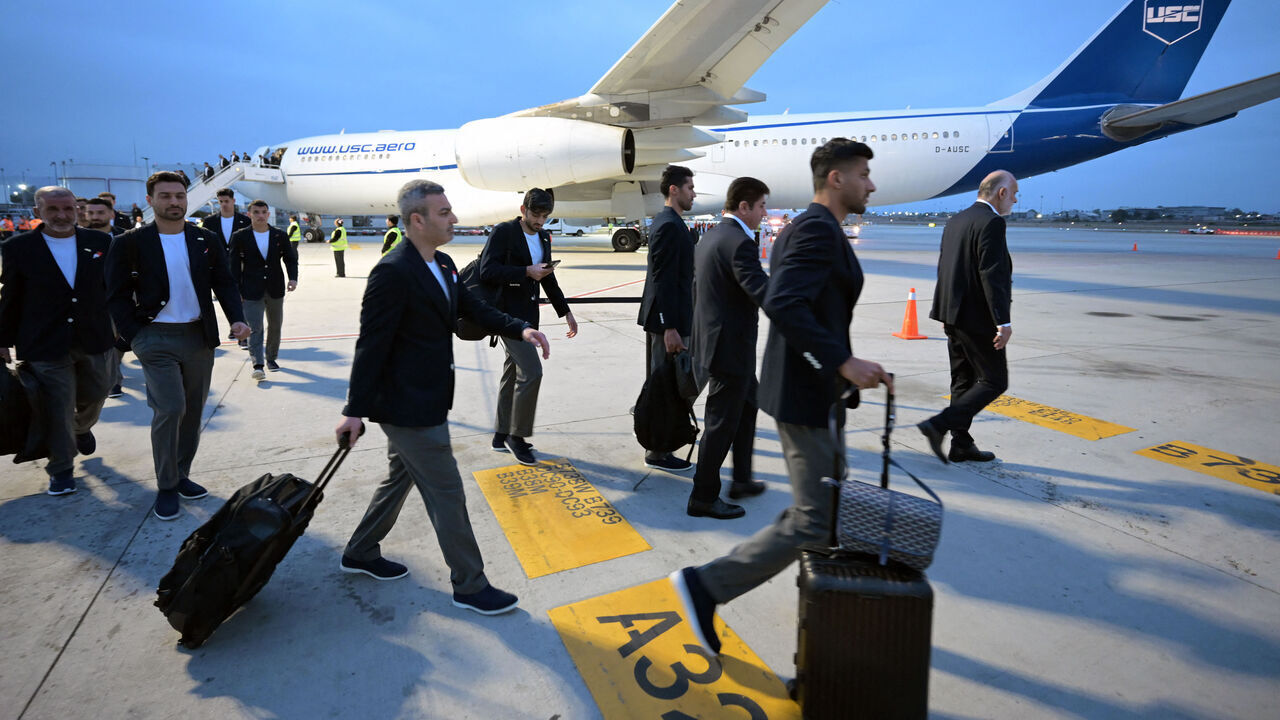 Iran's players walk on the tarmac on arrival at the Tijuana International Airport in Tijuana, Mexico on June 7, 2026, ahead of the FIFA 2026 World Cup football tournament.