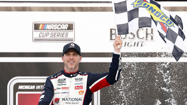 BROOKLYN, MICHIGAN - JUNE 07: Denny Hamlin, driver of the #11 National Debt Relief Toyota, celebrates in victory lane after winning the NASCAR Cup Series FireKeepers Casino 400 at Michigan International Speedway on June 07, 2026 in Brooklyn, Michigan.