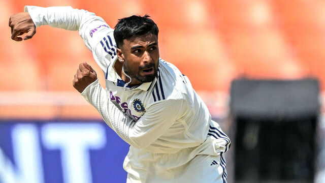 India's Manav Suthar bowls during the second day of the only Test cricket match between India and Afghanistan at the Maharaja Yadavindra Singh International Cricket Stadium on the outskirts of Chandigarh on June 7, 2026. / -- IMAGE RESTRICTED TO EDITORIAL USE - STRICTLY NO COMMERCIAL USE --