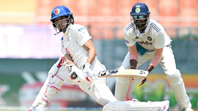 Afghanistan's Sediqullah Atal (L) plays a shot during the third day of the only Test cricket match between India and Afghanistan at the Maharaja Yadavindra Singh International Cricket Stadium on the outskirts of Chandigarh on June 8, 2026. / -- IMAGE RESTRICTED TO EDITORIAL USE - STRICTLY NO COMMERCIAL USE --