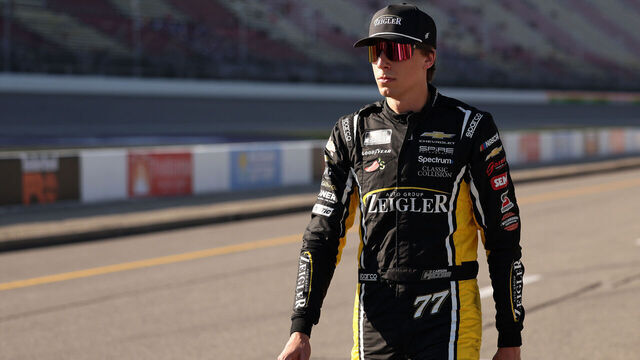 BROOKLYN, MICHIGAN - JUNE 06: Carson Hocevar, driver of the #77 Zeigler Auto Group Chevrolet, walks the grid during qualifying for the NASCAR Cup Series FireKeepers Casino 400 at Michigan International Speedway on June 06, 2026 in Brooklyn, Michigan.