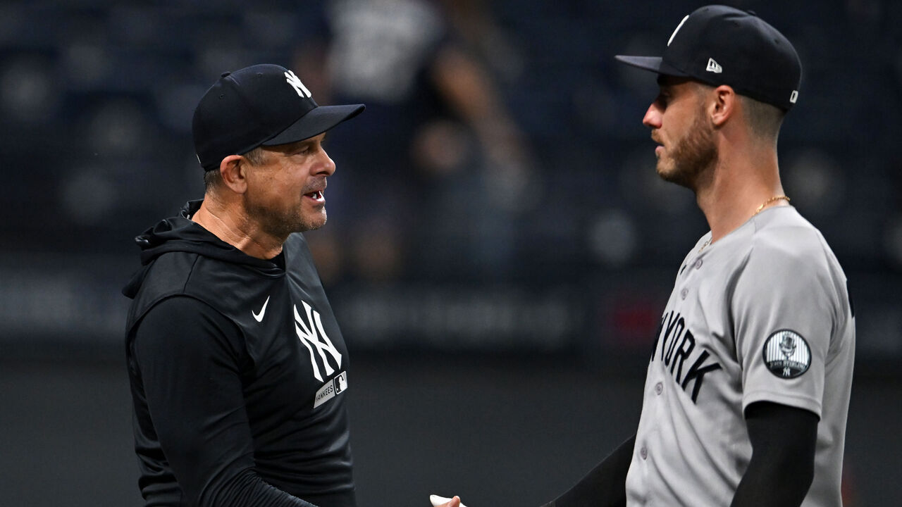 CLEVELAND, OHIO - JUNE 08: Manager Aaron Boone #17 and Cody Bellinger #35 of the New York Yankees celebrate the team's 7-5 win over the Cleveland Guardians in ten innings at Progressive Field on June 08, 2026 in Cleveland, Ohio.