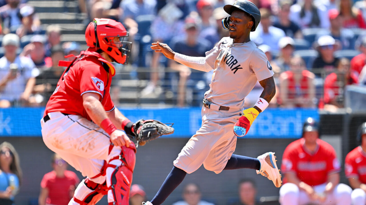 CLEVELAND, OHIO - JUNE 10: Jazz Chisholm Jr. #13 of the New York Yankees scores as catcher Austin Hedges #27 of the Cleveland Guardians waits for the throw during the seventh inning at Progressive Field on June 10, 2026 in Cleveland, Ohio.