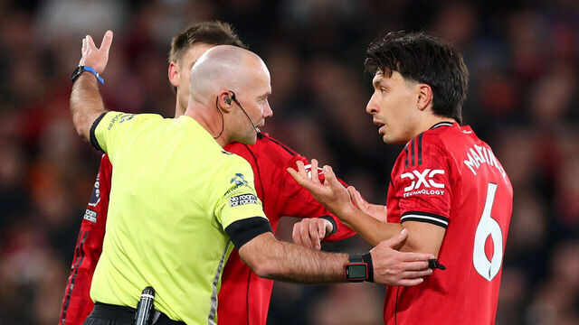 MANCHESTER, ENGLAND - APRIL 13: Referee Paul Tierney speaks with Lisandro Martinez of Manchester United after showing him a red card for pulling the hair of Dominic Calvert-Lewin of Leeds United during the Premier League match between Manchester United and Leeds United at Old Trafford on April 13, 2026 in Manchester, England.