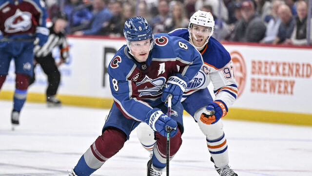 DENVER , CO - MARCH 10: Cale Makar (8) of the Colorado Avalanche controls the puck as Connor McDavid (97) of the Edmonton Oilers chases during the third period of the Oilers' 4-3 win at Ball Arena on Tuesday, March 10, 2026.