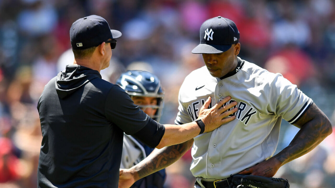 CLEVELAND, OH - JULY 02: Aroldis Chapman #54 of the New York Yankees is taken out of the game by manager Aaron Boone #17 during the seventh inning of game one of a doubleheader against the Cleveland Guardians at Progressive Field on July 2, 2022 in Cleveland, Ohio.