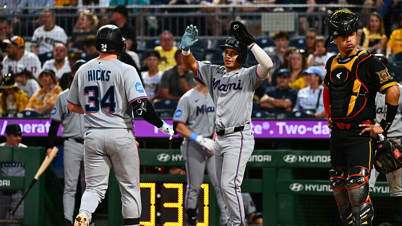 PITTSBURGH, PENNSYLVANIA - JUNE 12: Liam Hicks #34 of the Miami Marlins is met at home plate by Javier Sanoja #8 after hitting a two-run home run in the eighth inning during the game against the Pittsburgh Pirates at PNC Park on June 12, 2026 in Pittsburgh, Pennsylvania.