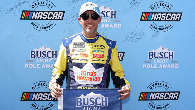 LONG POND, PENNSYLVANIA - JUNE 13: Denny Hamlin, driver of the #11 King's Hawaiian Shake 'Em Bites Toyota, poses for photos after winning the pole award during qualifying for the NASCAR Cup Series Great American Getaway 400 presented by VISITPA at Pocono Raceway on June 13, 2026 in Long Pond, Pennsylvania.