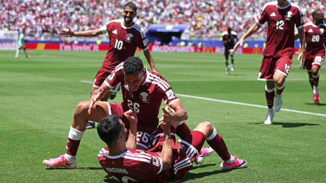 SANTA CLARA, CALIFORNIA - JUNE 13: Boualem Khoukhi #16 of Qatar celebrates with teammates after scoring the team's first goal during the FIFA World Cup 2026 Group B match between Qatar and Switzerland at San Francisco Bay Area Stadium on June 13, 2026 in Santa Clara, California.