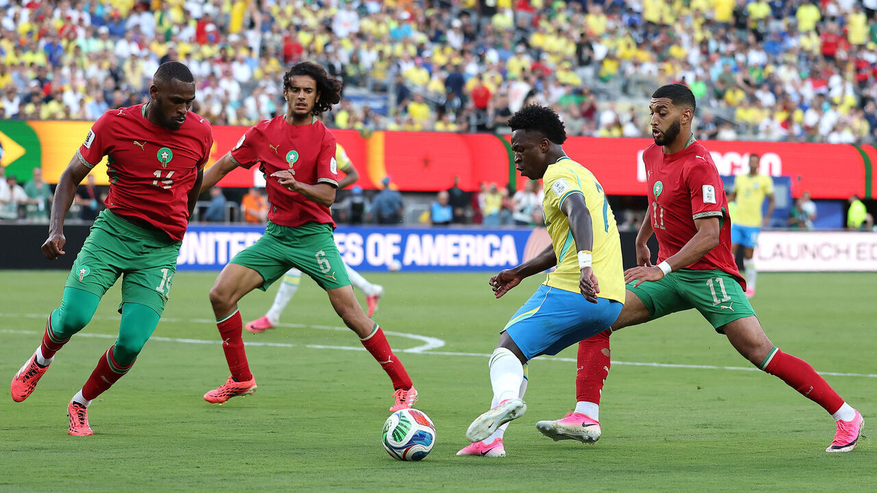 EAST RUTHERFORD, NEW JERSEY - JUNE 13: Vinicius Junior #7 of Brazil controls the ball under pressure from Issa Diop #14, Ayyoub Bouaddi #6 and Ismael Saibari #11 of Morocco during the FIFA World Cup 2026 Group C match between Brazil and Morocco at New York New Jersey Stadium on June 13, 2026 in East Rutherford, New Jersey.