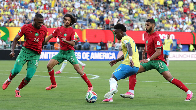EAST RUTHERFORD, NEW JERSEY - JUNE 13: Vinicius Junior #7 of Brazil controls the ball under pressure from Issa Diop #14, Ayyoub Bouaddi #6 and Ismael Saibari #11 of Morocco during the FIFA World Cup 2026 Group C match between Brazil and Morocco at New York New Jersey Stadium on June 13, 2026 in East Rutherford, New Jersey.
