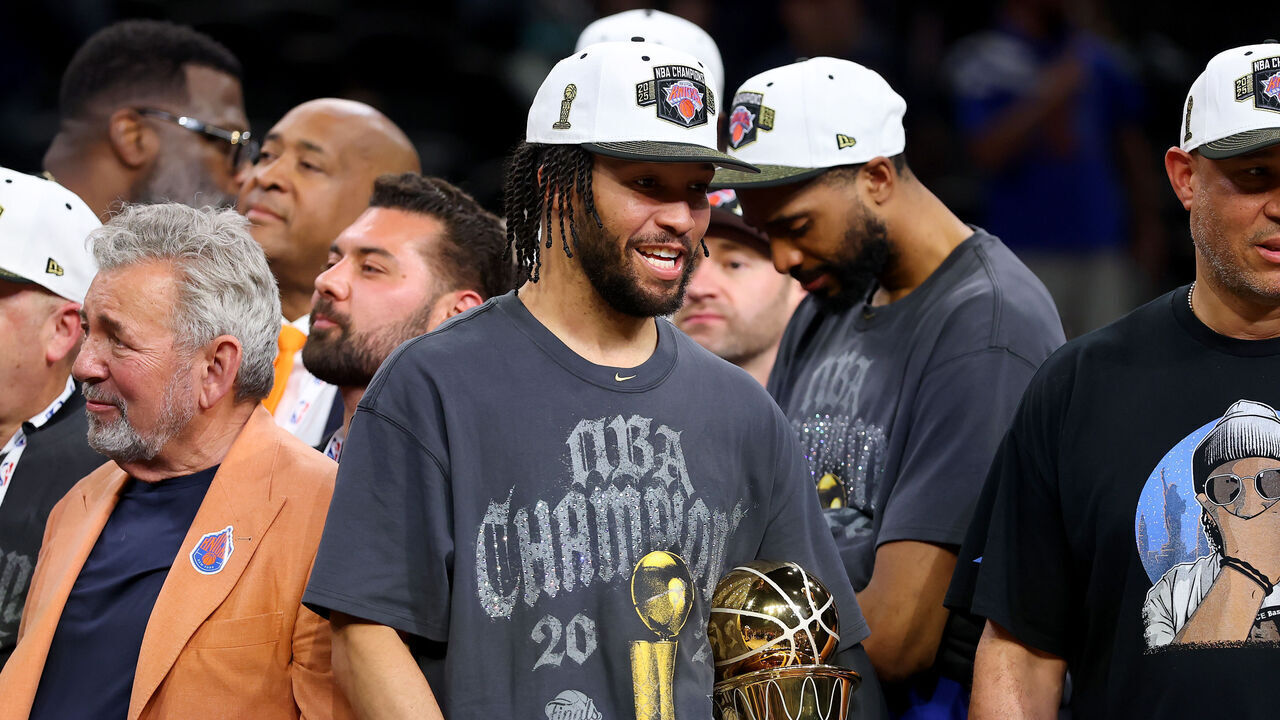 SAN ANTONIO, TEXAS - JUNE 13: Jalen Brunson #11 of the New York Knicks celebrates with the Bill Russell NBA Finals Most Valuable Player Award trophy and his father Rick Brunson after defeating the San Antonio Spurs in Game Five of the 2026 NBA Finals at Frost Bank Center on June 13, 2026 in San Antonio, Texas.