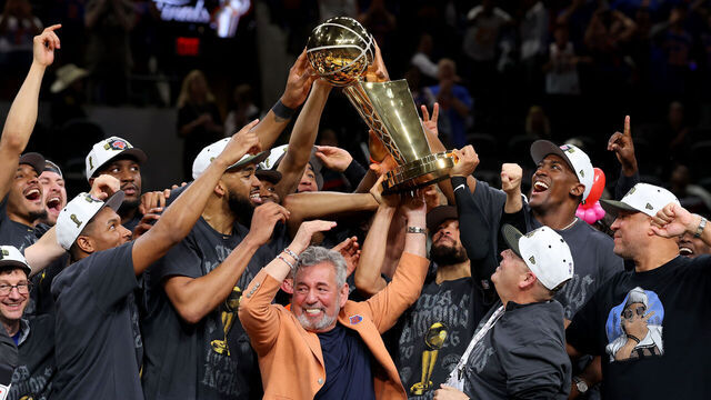 SAN ANTONIO, TEXAS - JUNE 13: New York Knicks owner James Dolan and president Leon Rose lift the Larry O'Brien Championship Trophy after their team defeated the San Antonio Spurs in Game Five of the 2026 NBA Finals at Frost Bank Center on June 13, 2026 in San Antonio, Texas.