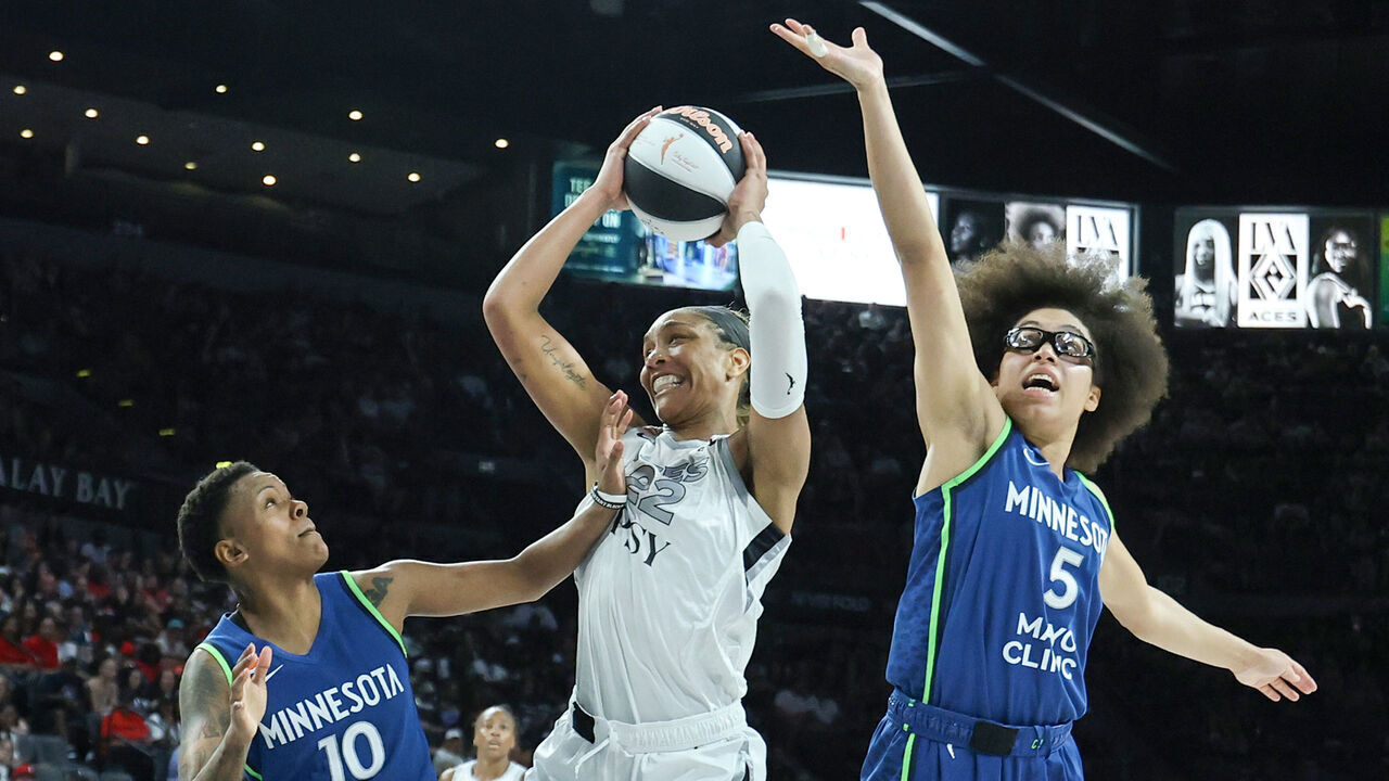 LAS VEGAS, NEVADA - JUNE 13: A'ja Wilson #22 of the Las Vegas Aces grabs a rebound against Courtney Williams #10 and Olivia Miles #5 of the Minnesota Lynx in the second quarter of their game at Michelob ULTRA Arena on June 13, 2026 in Las Vegas, Nevada. The Aces defeated the Lynx 100-97.