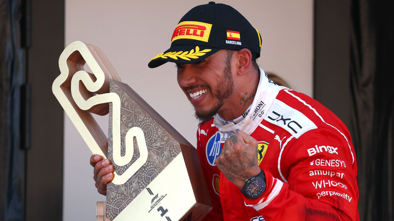 BARCELONA, SPAIN - JUNE 14: Race winner Lewis Hamilton of Great Britain and Scuderia Ferrari celebrates on the podium with his trophy during the F1 Grand Prix of Barcelona-Catalunya at Circuit de Barcelona-Catalunya on June 14, 2026 in Barcelona, Spain.