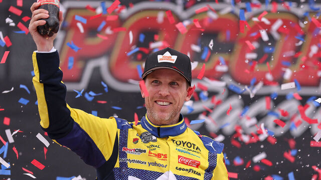 LONG POND, PENNSYLVANIA - JUNE 14: Denny Hamlin, driver of the #11 King's Hawaiian Shake 'Em Bites Toyota, celebrates in victory lane after winning the NASCAR Cup Series Great American Getaway 400 presented by VISITPA at Pocono Raceway on June 14, 2026 in Long Pond, Pennsylvania.