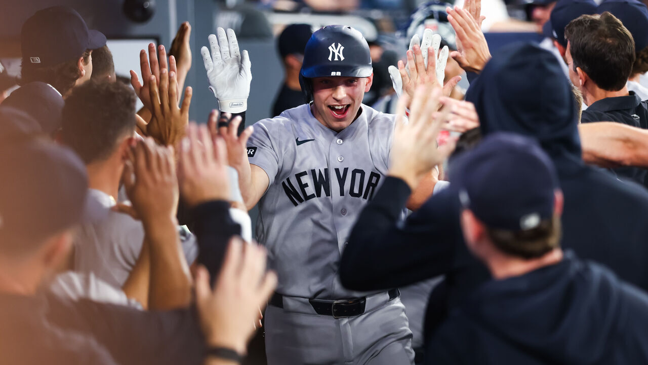 TORONTO, CANADA - JUNE 14: Ben Rice #22 of the New York Yankees celebrates in the dugout after hitting a two-run home run in the ninth inning to score in Ryan McMahon #19 during their MLB game against the Toronto Blue Jays at Rogers Centre on June 14, 2026 in Toronto, Ontario, Canada.