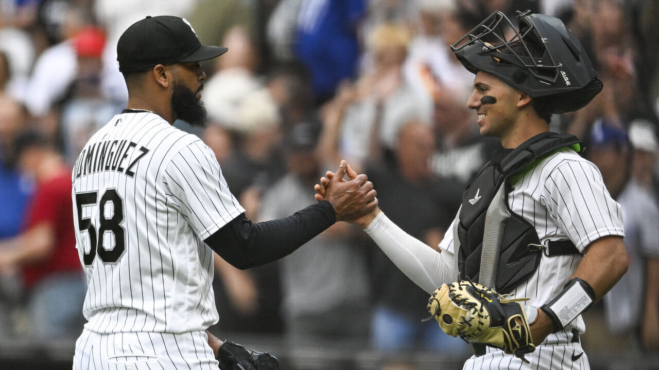CHICAGO, ILLINOIS - JUNE 14: Seranthony Domínguez #58 and Drew Romo #36 of the Chicago White Sox high-five after defeating the Los Angeles Dodgers 6-4 at Rate Field on June 14, 2026 in Chicago, Illinois.