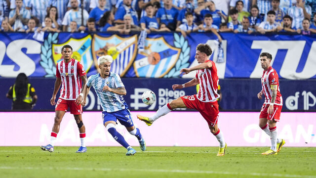MALAGA, SPAIN - JUNE 14: Chupe of Malaga CF and Stefan Dzodic of UD Almeria in action during the Liga Hypermotion, first leg of the Playoff for LaLiga EA Sports promotion, football match played between Malaga CF and UD Almeria at La Rosaleda stadium on June 14, 2026, in Malaga, Spain.