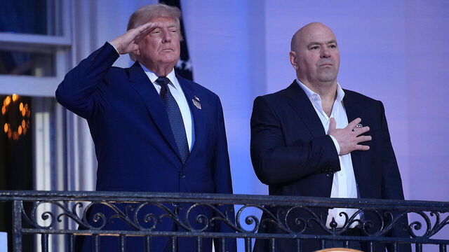 WASHINGTON, DC - JUNE 14: U.S. President Donald Trump and UFC President and CEO Dana White stand on the South Portico balcony during UFC Freedom 250 on the South Lawn of the White House on June 14, 2026 in Washington, DC. President Trump is hosting a series of Ultimate Fighting Championship matches on his 80th birthday, which the White House is calling "a once-in-a-generation celebration of the American fighting spirit.”
