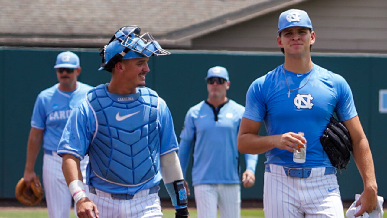 CHAPEL HILL, NORTH CAROLINA - JUNE 06: Catcher Colin Hynek #23 and pitcher Jason DeCaro #29 of the University of North Carolina Tar Heels walk towards the dugout prior to the start of the game against the University of Southern California Trojans at Boshamer Stadium on June 06, 2026 in Chapel Hill, North Carolina.