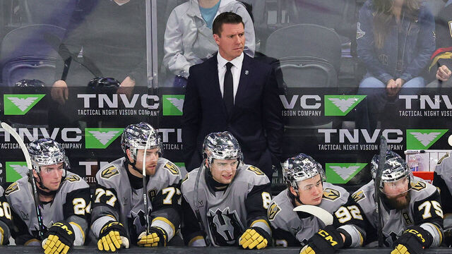 HENDERSON, NEVADA - FEBRUARY 20: Head coach Ryan Craig of the Henderson Silver Knights handles bench duties behind Trevor Connelly #24, Kai Uchacz #77, Mathieu Cataford #8, Sloan Stanick #92 and Mitch McLain #75 in the first period of their game against the Abbotsford Canucks at Lee's Family Forum on February 20, 2026 in Henderson, Nevada. The Silver Knights defeated the Canucks 6-3.