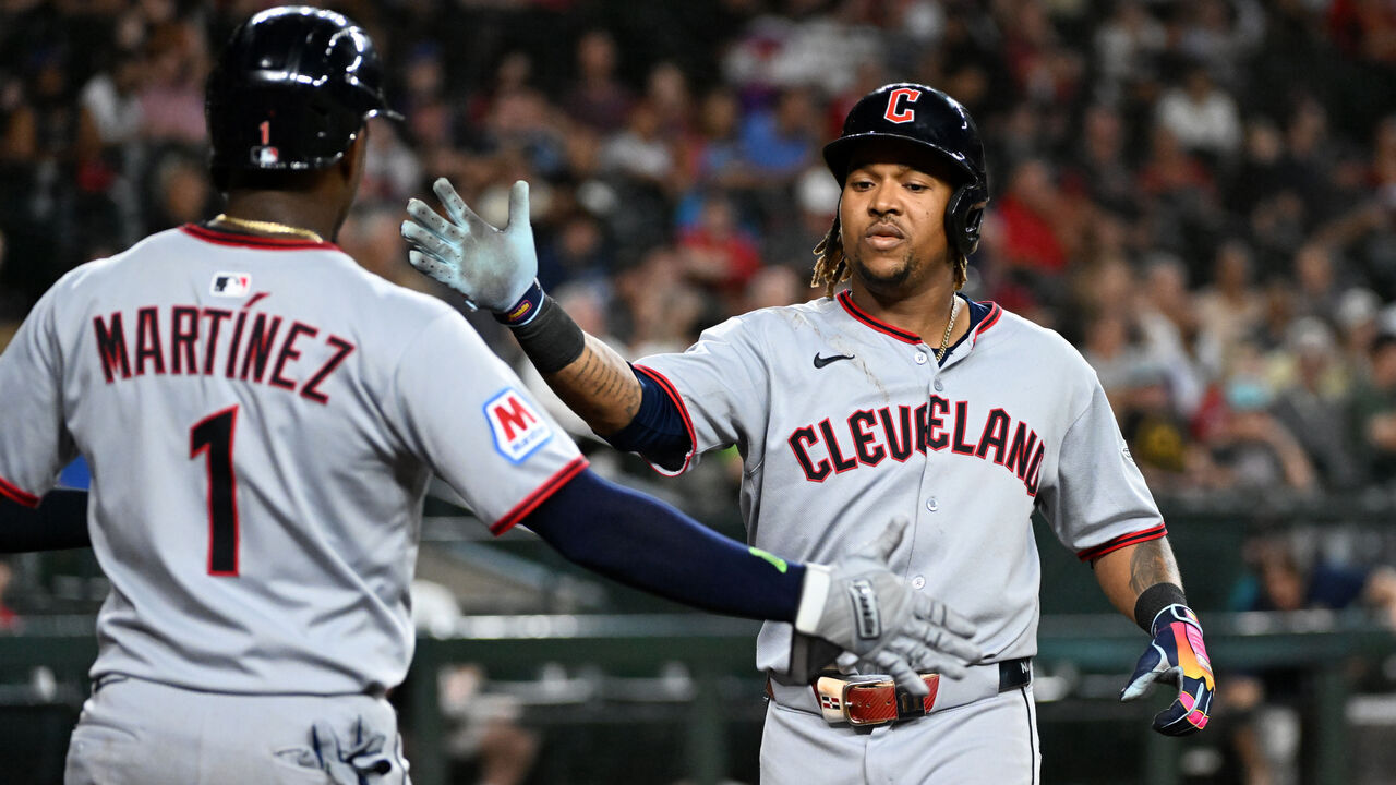 PHOENIX, ARIZONA - AUGUST 19: Jose Ramirez #11 of the Cleveland Guardians celebrates with Angel Martinez #1 after hitting a two run home run against the Arizona Diamondbacks during the fifth inning at Chase Field on August 19, 2025 in Phoenix, Arizona.