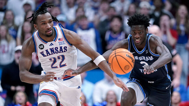 LAWRENCE, KANSAS - JANUARY 31: Darryn Peterson #22 of the Kansas Jayhawks and forward AJ Dybantsa #3 of the BYU Cougars chase down a loose ball in the first half at Allen Fieldhouse on January 31, 2026 in Lawrence, Kansas.