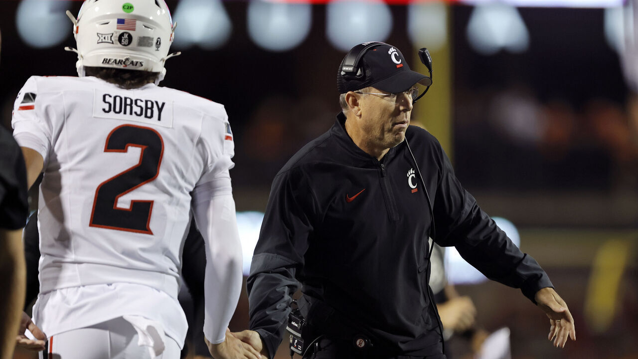 STILLWATER, OK - OCTOBER 18: Head coach Scott Satterfield congratulates quarterback Brendan Sorsby #2 of the Cincinnati Bearcats after a 26-yard touchdown on a four-yard throw on the first drive against the Oklahoma State Cowboys in the first quarter at Boone Pickens Stadium on October 18, 2025 in Stillwater, Oklahoma. Cincinnati won 49-17.