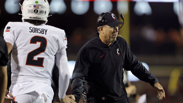 STILLWATER, OK - OCTOBER 18: Head coach Scott Satterfield congratulates quarterback Brendan Sorsby #2 of the Cincinnati Bearcats after a 26-yard touchdown on a four-yard throw on the first drive against the Oklahoma State Cowboys in the first quarter at Boone Pickens Stadium on October 18, 2025 in Stillwater, Oklahoma. Cincinnati won 49-17.