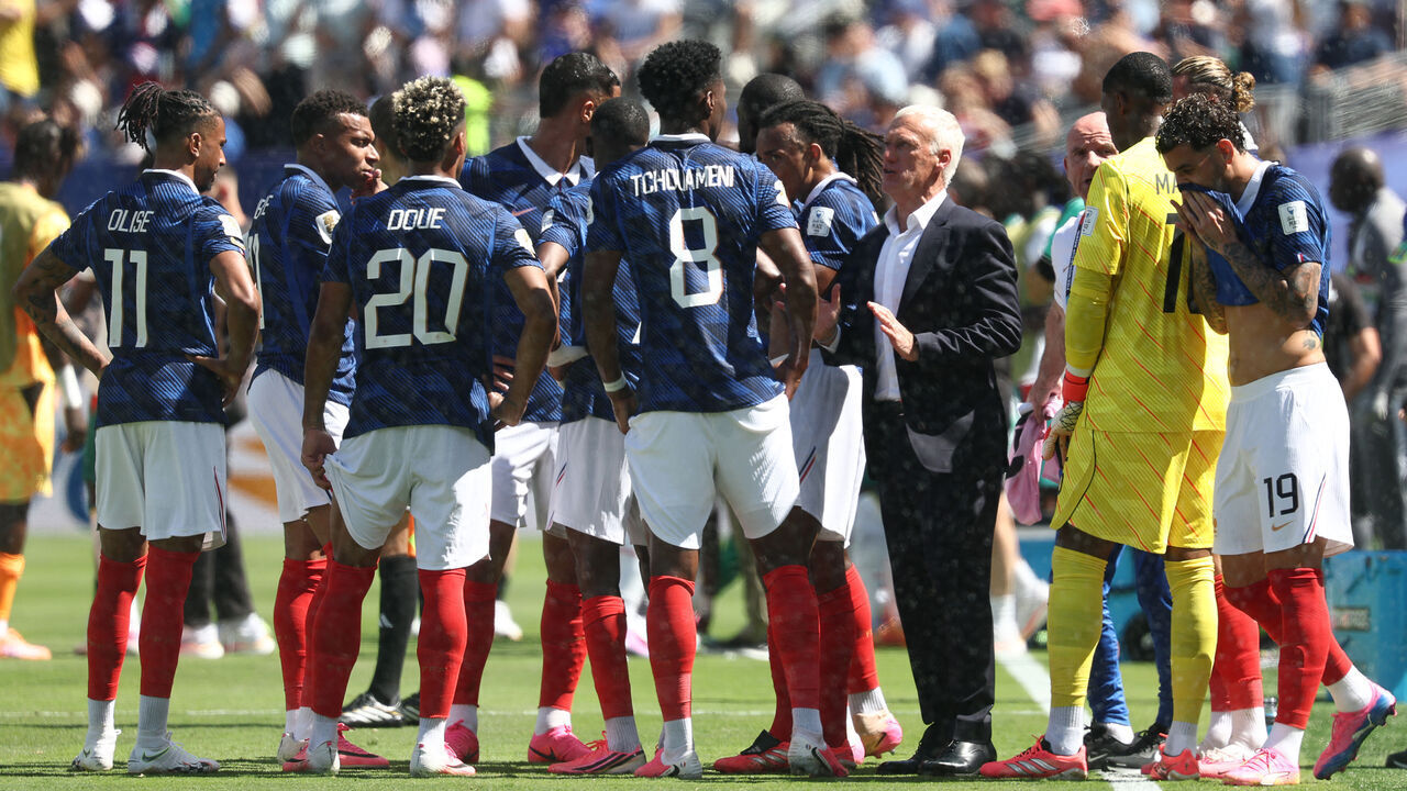 France's head coach Didier Deschamps talks to his players during the hydration break at the 2026 World Cup Group I football match between France and Senegal at the New York/New Jersey Stadium in East Rutherford on June 16, 2026.
