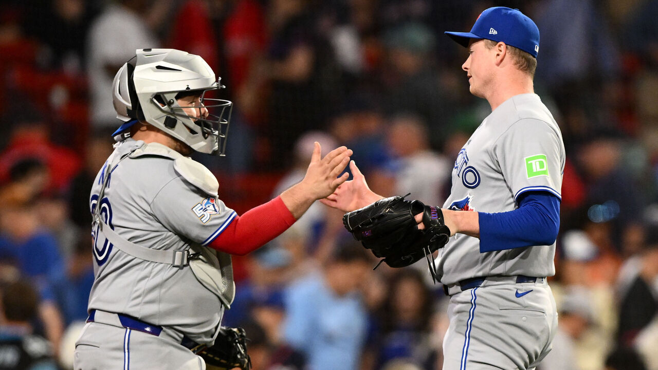 BOSTON, MASSACHUSETTS - JUNE 17: Louis Varland #77 of the Toronto Blue Jays high-fives Alejandro Kirk #30 after a game against the Boston Red Sox at Fenway Park on June 17, 2026 in Boston, Massachusetts.