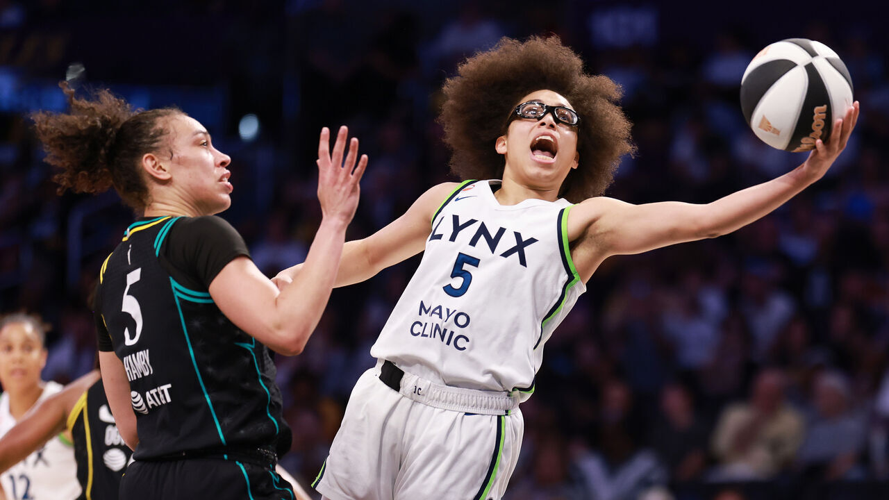 LOS ANGELES, CALIFORNIA - JUNE 17: Olivia Miles #5 of the Minnesota Lynx drives to the basket against Dearica Hamby #5 of the Los Angeles Sparks during the first half at Crypto.com Arena on June 17, 2026 in Los Angeles, California.