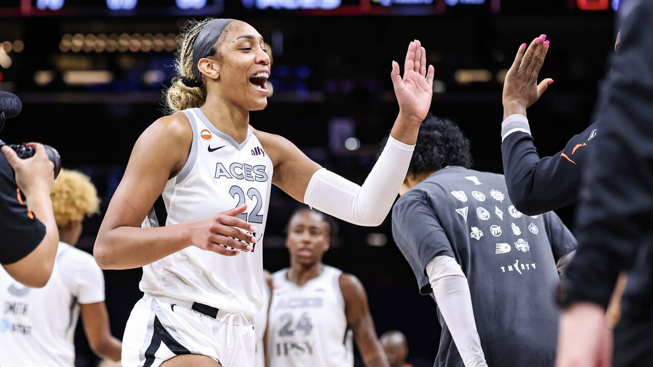 PHOENIX, ARIZONA - JUNE 17: A'ja Wilson #22 of the Las Vegas Aces high fives teammates after an 86-76 win against the Phoenix Mercury at Mortgage Matchup Center on June 17, 2026 in Phoenix, Arizona.