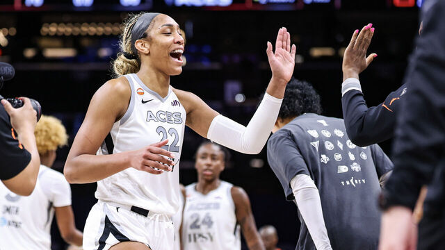 PHOENIX, ARIZONA - JUNE 17: A'ja Wilson #22 of the Las Vegas Aces high fives teammates after an 86-76 win against the Phoenix Mercury at Mortgage Matchup Center on June 17, 2026 in Phoenix, Arizona.