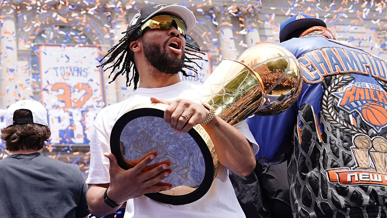 NEW YORK, NEW YORK - JUNE 18: Jalen Brunson #11 of the New York Knicks celebrates with the Larry O'Brien Championship Trophy during the New York Knicks Championship ticker tape parade and victory rally celebrating winning the 2026 NBA Finals on June 18, 2026 in New York City. The New York Knicks defeated the San Antonio Spurs in five games to win their first NBA Championship in 53 years.