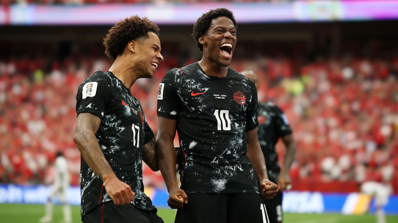 VANCOUVER, BRITISH COLUMBIA - JUNE 18: Jonathan David #10 of Canada celebrates with teammate Tajon Buchanan #17 after scoring his team's second goal during the FIFA World Cup 2026 Group B match between Canada and Qatar at BC Place Vancouver on June 18, 2026 in Vancouver, British Columbia.