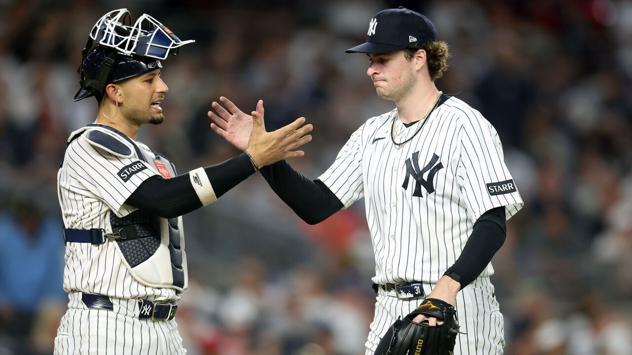 NEW YORK, NY - JUNE 19: Cam Schlittler #31 of the New York Yankees and J.C. Escarra #25 shake hands during the game between the Cincinnati Reds and the New York Yankees at Yankee Stadium on Friday, June 19, 2026 in New York, New York.