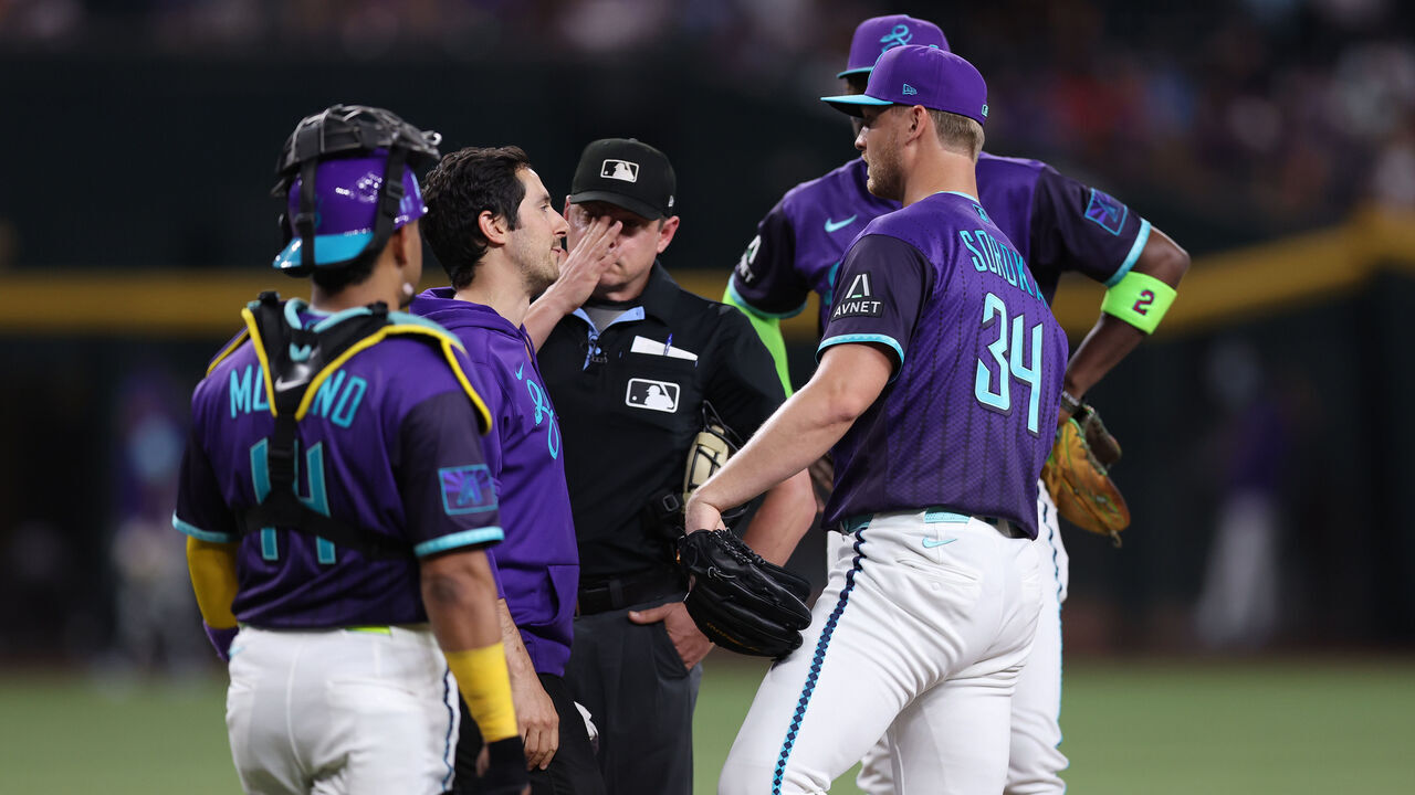 PHOENIX, ARIZONA - JUNE 19: Mike Soroka #34 of the Arizona Diamondbacks (right) talks to a trainer during the second inning of the MLB game against the Minnesota Twins at Chase Field on June 19, 2026 in Phoenix, Arizona. Soroka left the game in the second inning due to a leg injury.