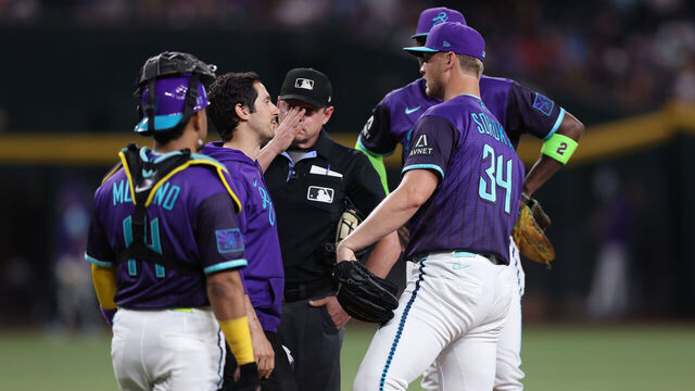 PHOENIX, ARIZONA - JUNE 19: Mike Soroka #34 of the Arizona Diamondbacks (right) talks to a trainer during the second inning of the MLB game against the Minnesota Twins at Chase Field on June 19, 2026 in Phoenix, Arizona. Soroka left the game in the second inning due to a leg injury.