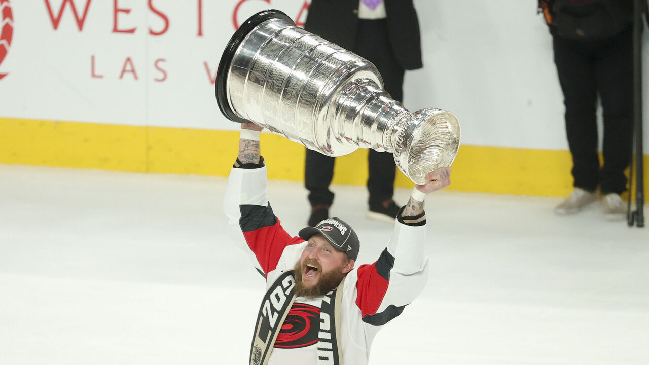 LAS VEGAS, NEVADA - JUNE 14: Nicolas Deslauriers #44 of the Carolina Hurricanes lifts the Stanley Cup after his team's 3-0 series clinching victory against the Vegas Golden Knights in Game Six of the 2026 Stanley Cup Final at T-Mobile Arena on June 14, 2026 in Las Vegas, Nevada.