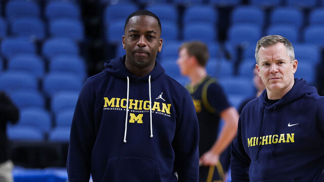 BUFFALO, NEW YORK - MARCH 18: Head coach Dusty May and assistant coach Mike Boynton Jr. of the Michigan Wolverines look on during practice day ahead of the first round of the 2026 NCAA Men's Basketball Tournament at KeyBank Center on March 18, 2026 in Buffalo, New York.