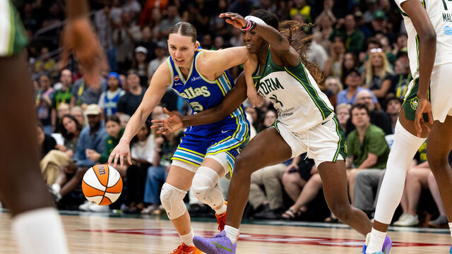 SEATTLE, WASHINGTON - JUNE 22: Paige Bueckers #5 of the Dallas Wings drives to the basket past Flau'jae Johnson #4 of the Seattle Storm during overtime at Climate Pledge Arena on June 22, 2026 in Seattle, Washington.