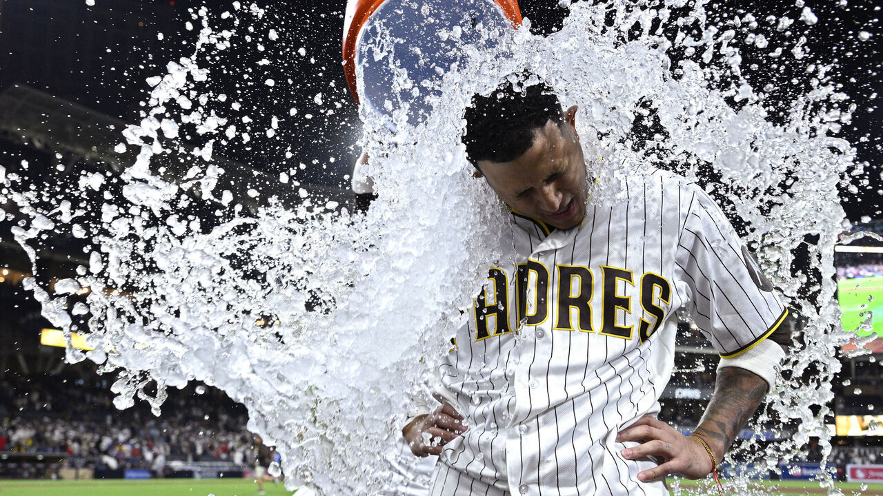 SAN DIEGO, CALIFORNIA - JUNE 23: Manny Machado #13 of the San Diego Padres is doused after hitting a walk-off single against the Atlanta Braves during the 10th inning at Petco Park on June 23, 2026 in San Diego, California.