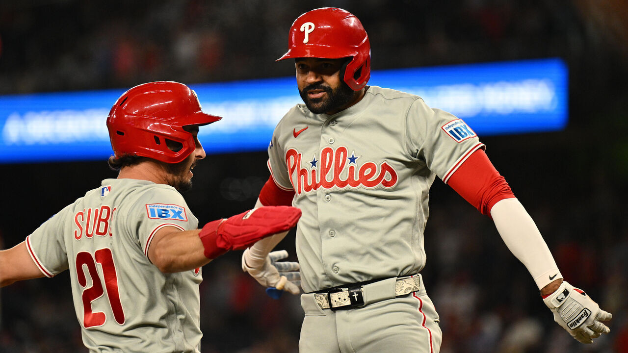 WASHINGTON, DC - JUNE 24: Derek Hill #49 of the Philadelphia Phillies (R) celebrates with Garrett Stubbs #21 at home plate after hitting a two-run home run in the ninth inning against the Washington Nationals at Nationals Park on June 24, 2026 in Washington, DC. Philadelphia defeated Washington 5-4.
